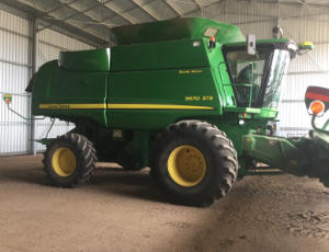 A John Deere 9670STS Combine Harvester A John Deere Combine Harvester parked in a shed